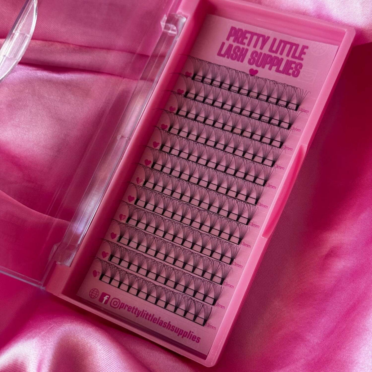 Pink eyelash extension tray with various lengths of soft, synthetic lashes for a glamorous look.