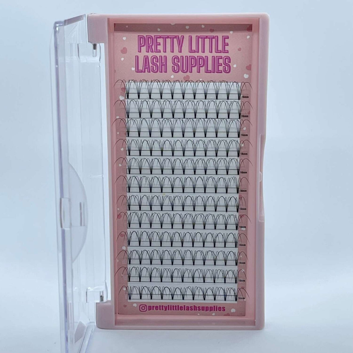 Clear eyelash extension tray in pink packaging, featuring multiple rows of black, pre-made fan lashes.