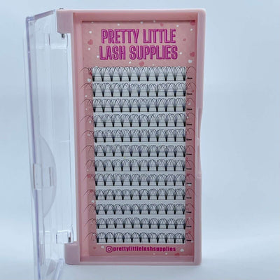 Black silk eyelash extensions in a clear tray with pink accents, perfect for professional lash artists.