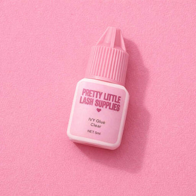 Pretty Little Lash Supplies IVY Clear Glue, 5ml, pink packaging on a soft pink background, perfect for lash extensions.