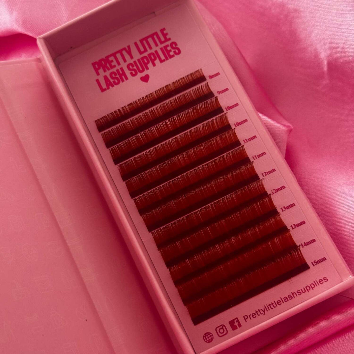 Synthetic brown eyelash extensions in varying lengths from 8mm to 15mm, packaged in a pink box.
