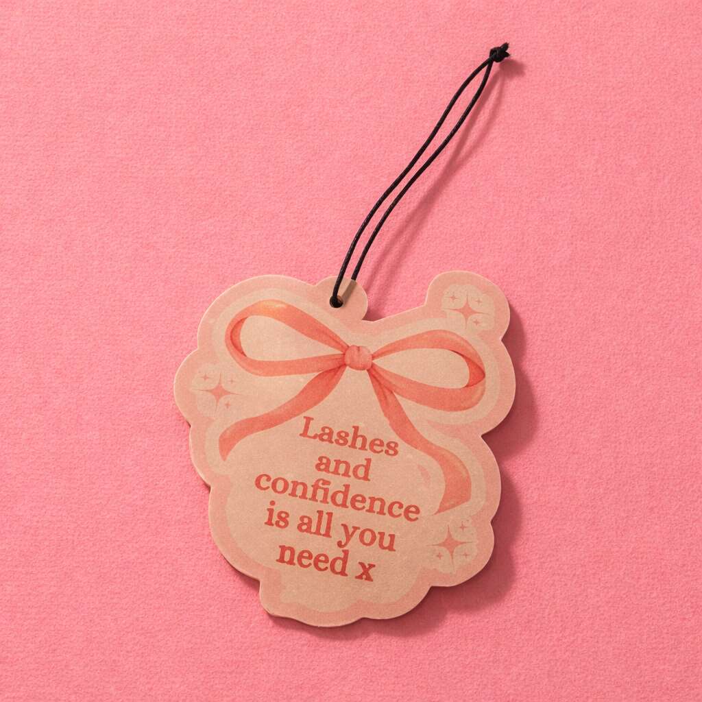 Pink car scent with a bow, text reads "Lashes and confidence is all you need x," ideal for beauty product packaging.