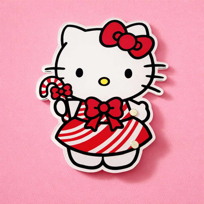 Cute Hello Kitty Christmas lash tile in red and white striped dress, holding a candy cane, on a pink background.