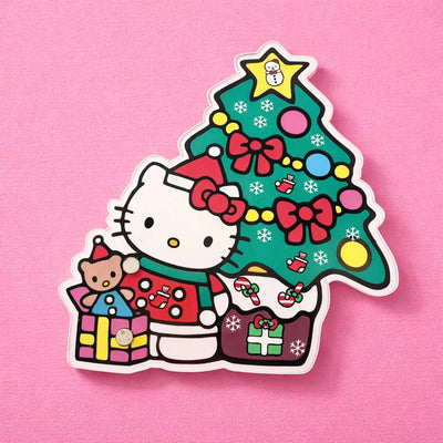 Cute Hello Kitty Christmas lash tile with a colorful tree, presents, and cheerful decorations on a pink background.