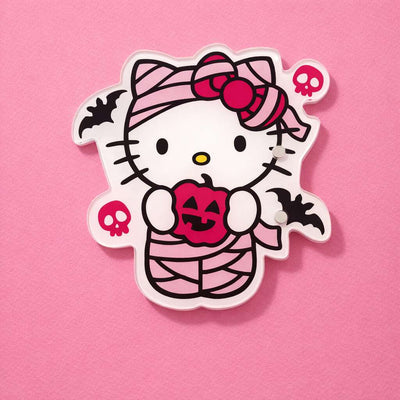 Cute Hello Kitty Halloween lash tile, featuring a pink and white mummy design, holding a pumpkin, with bats and skulls.
