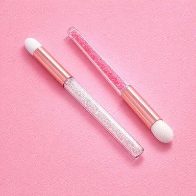Pink makeup brush set with glitter handles, featuring a dual-ended design and soft white bristles, perfect for cosmetics.