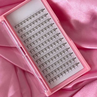 Pink eyelash extension tray featuring 16 rows of black individual lashes, ideal for volume and glamour styles.