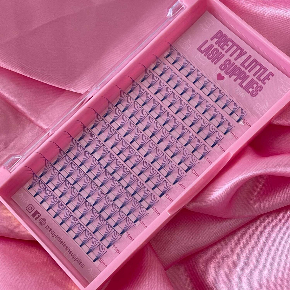 Pink lash extension tray with blue volume lashes in varying lengths, perfect for professional beauty applications.