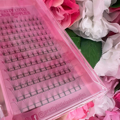 Pink lash supply tray featuring synthetic lashes in multiple lengths, perfect for creating stunning lash extensions.
