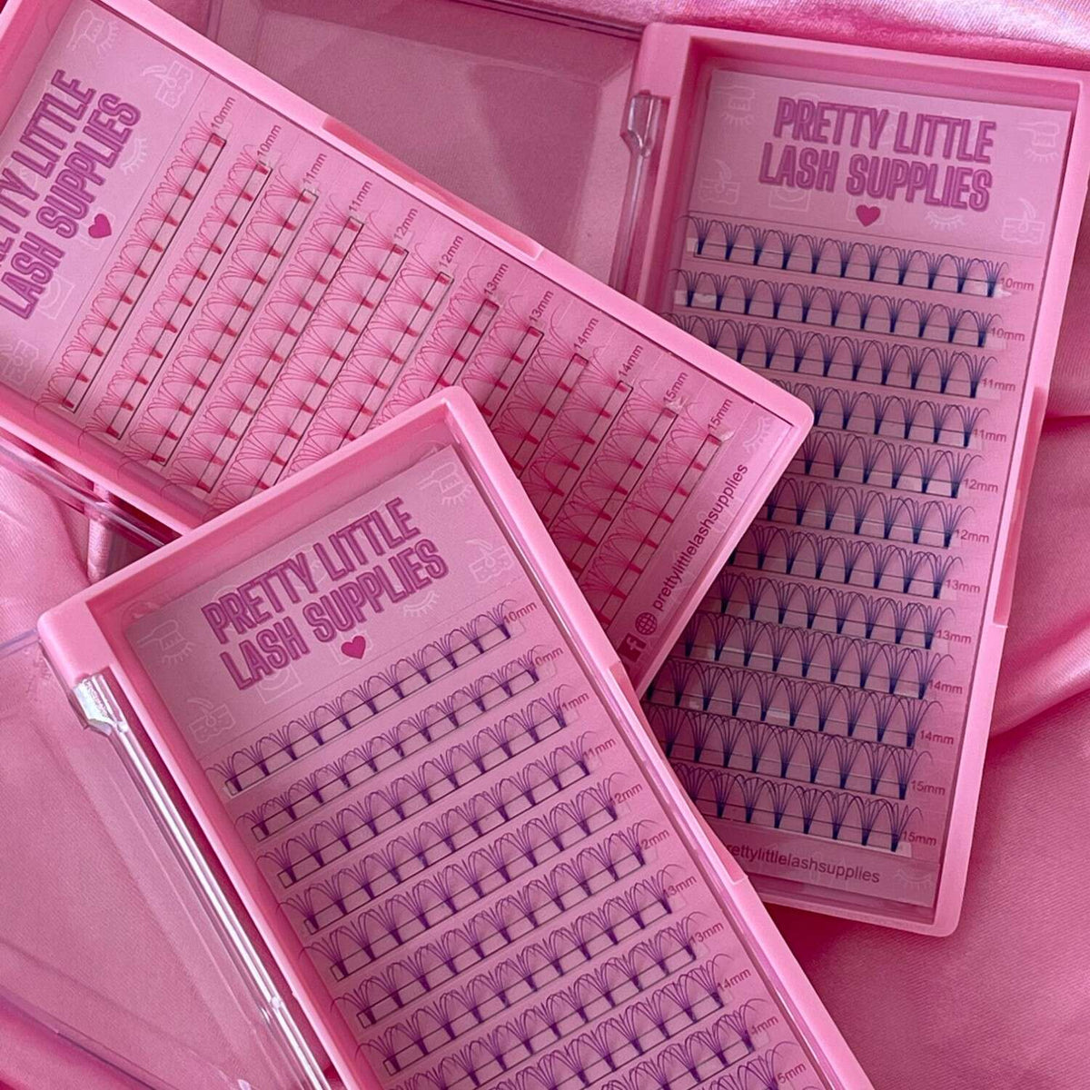 Pretty Little Lash Supplies in pink and purple trays, featuring varying lengths of high-quality synthetic lashes.