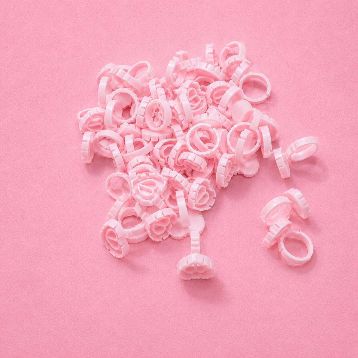 Pink plastic hair clips in a floral design, perfect for securing hair with a cute and stylish touch.