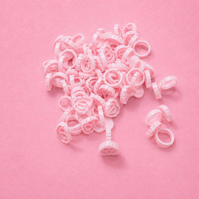 Pink plastic hair clips in a floral design, perfect for securing hair with a cute and stylish touch.