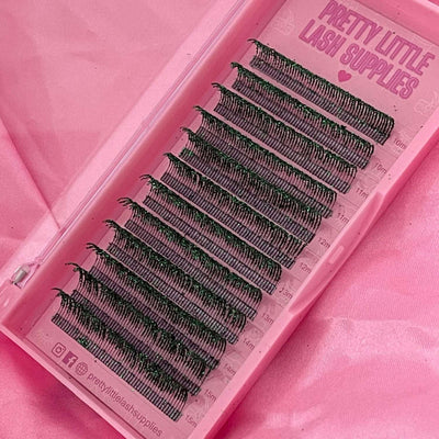 Black volume lash extensions in a clear case, featuring various lengths, on a pink background.