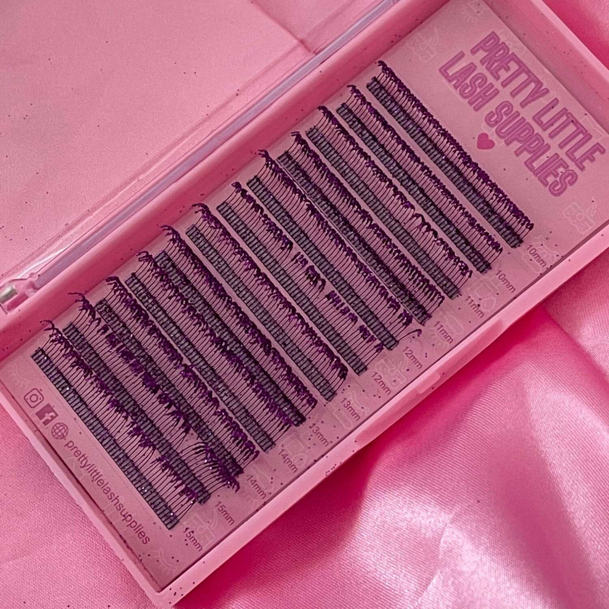 Black eyelash extensions in a pink tray, featuring various lengths from 8mm to 18mm for professional use.