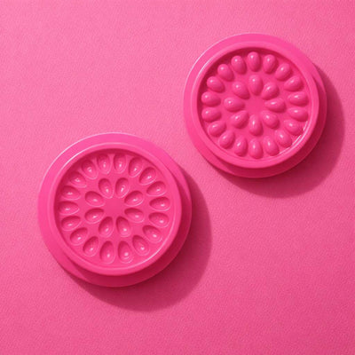 Bright pink silicone baking molds with floral designs, perfect for creating fun desserts and treats.