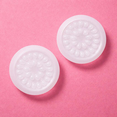 Clear silicone gel inserts with a flower-shaped design on a soft pink background. Perfect for enhancing comfort.