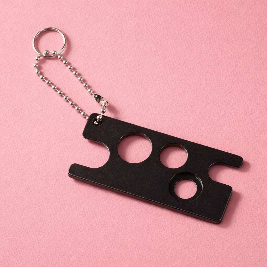 Black metal keychain bottle opener with three circular cutouts, elegantly designed for durability and style.