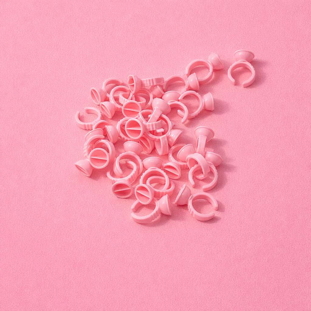Pink plastic hair clips scattered on a soft pink background, perfect for styling and organizing hair.