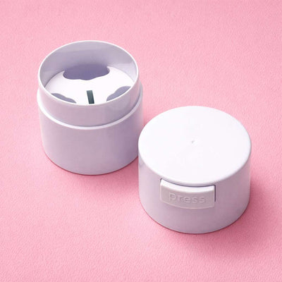 White plastic storage container with a press-top lid, featuring a rounded design, on a pink background.