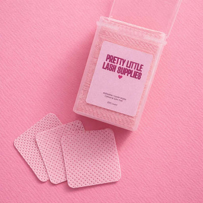 Adhesive lash tape in pink polka dot pattern, 200 count, stored in a clear container, ideal for eyelash extensions.