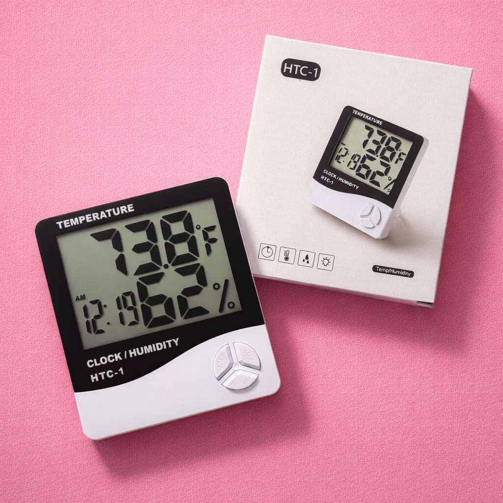 Digital clock and humidity monitor HTC-1, black and white design, displaying 73.8°F and 12.08% humidity, with packaging.