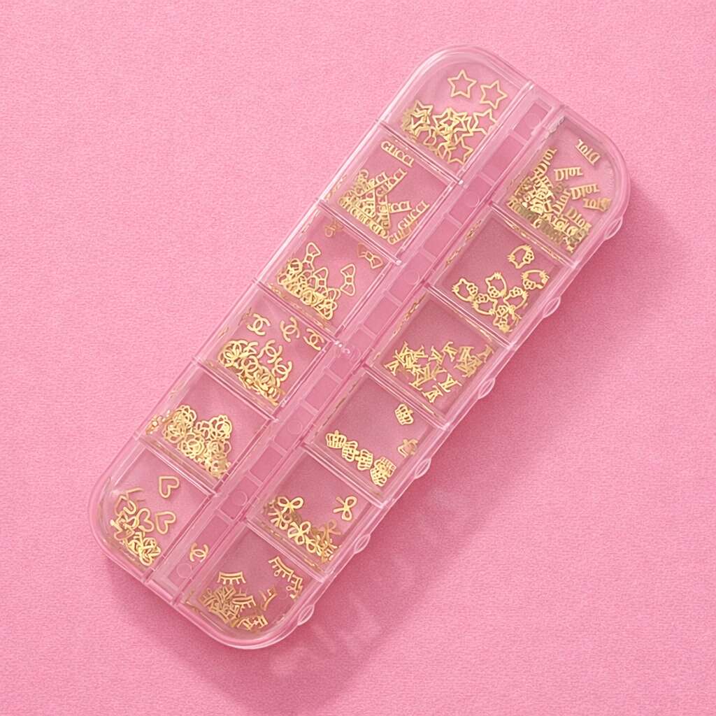 Gold metal charms in a clear organizer, featuring various shapes like hearts and stars, perfect for crafts and DIY projects.