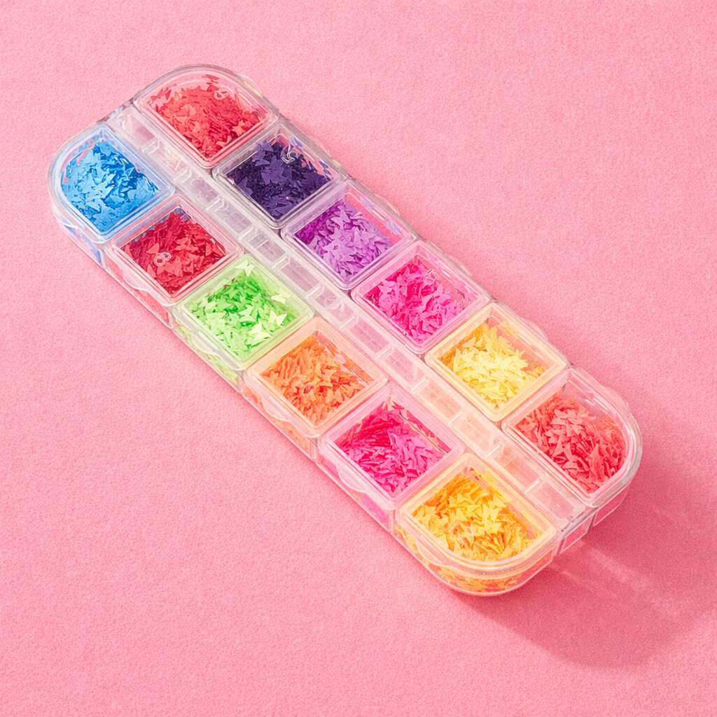 Colorful craft supply kit with vibrant shredded paper in pink, purple, green, blue, and yellow in a clear organizer.