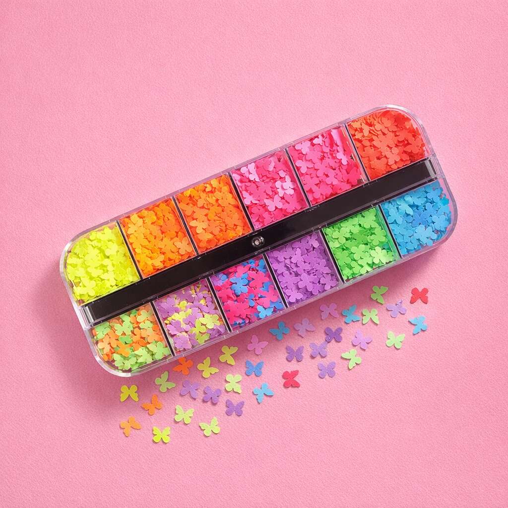 Colorful butterfly confetti in a clear organizer, featuring neon pink, orange, yellow, green, blue, and purple shades.