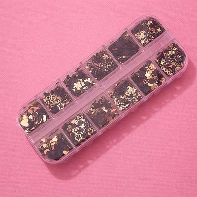 Black and gold star and heart confetti in a clear organizer box, perfect for crafts and decoration.