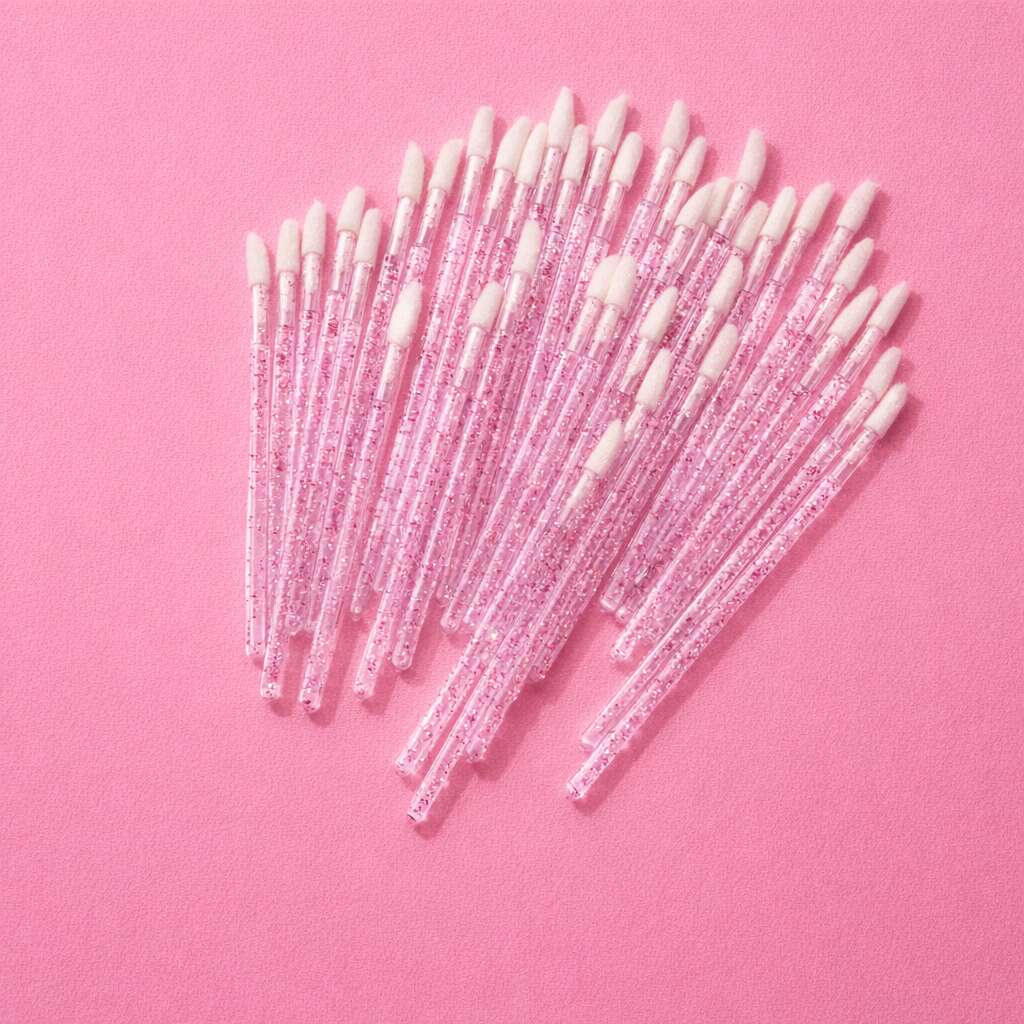 Pink glitter cosmetic applicators with soft white tips, perfect for makeup application and touch-ups.