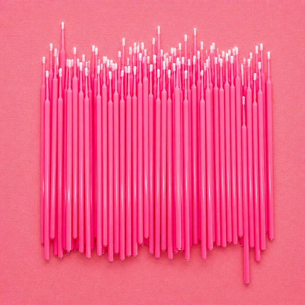Bright pink plastic crochet hooks arranged neatly, ideal for crafting and DIY projects.