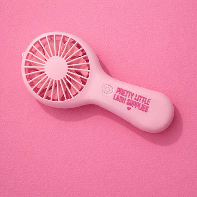 Pink handheld fan, featuring "Pretty Little Lash Supplies" in matching pink lettering.