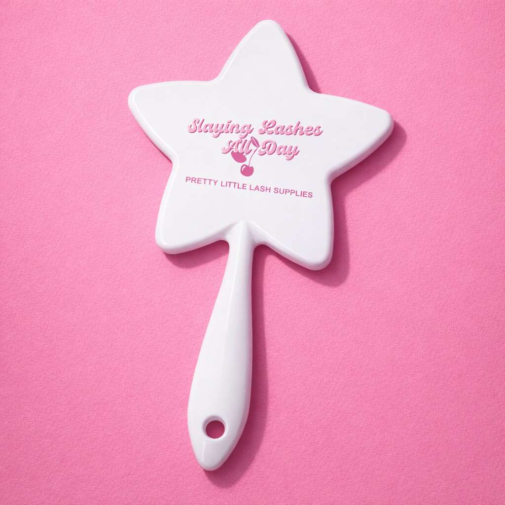 White star-shaped cosmetic mirror with "Slaying Lashes All Day" print in pink, perfect for beauty enthusiasts.