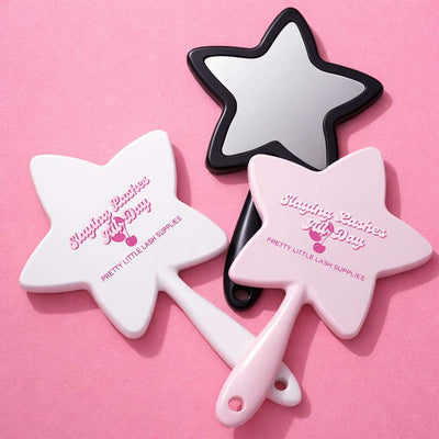 Star-shaped handheld mirrors in pink, white, and black with "Slaying Lashes All Day" print, perfect for beauty lovers.