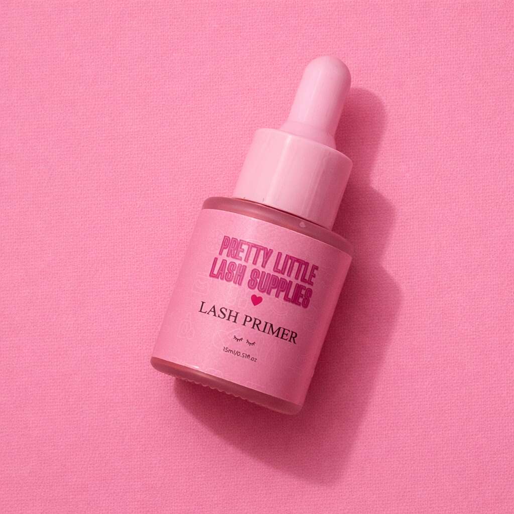 Pink lash primer in a glass dropper bottle with a pink label against a pastel pink backdrop.
