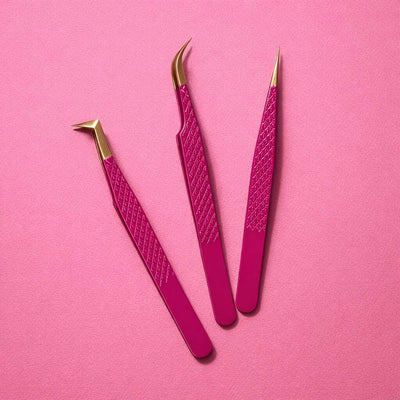 Set of three pink tweezers with gold accents, featuring precision tips for perfect grooming and styling.