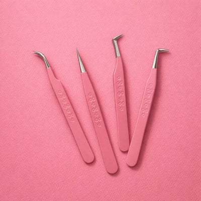 Set of 4 pink stainless steel tweezers with heart-patterned grips, ideal for precision grooming and styling.