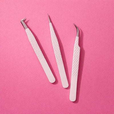 Set of three white stainless steel tweezers on pink background; textured grip, precision tips for beauty or crafting.
